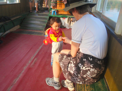 Granddaughter delicately takes the nut from Terry's half-shell.